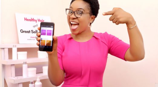 HerVenture user in Nigeria points to the app on her phone.