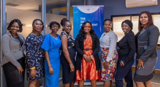 Sola Adesakin poses for a photograph with some of her students in her office, in Victoria Island, Lagos, Nigeria, on 4 August 2022. The Cherie Blair Foundation for Women's Road to Growth programme has supported over 3,000 women entrepreneurs to build and develop their businesses.