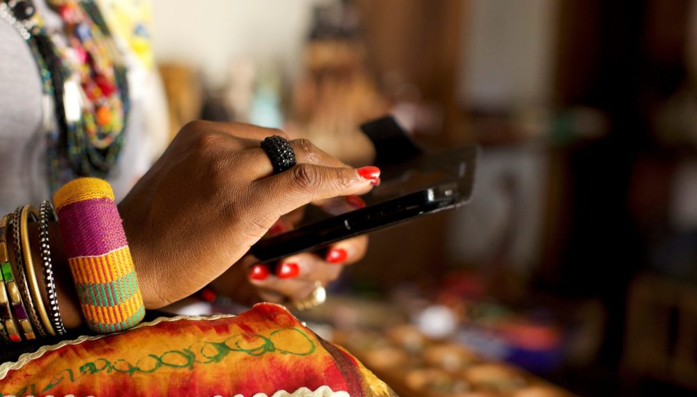 Woman entrepreneurs' hands using the HerVenture app