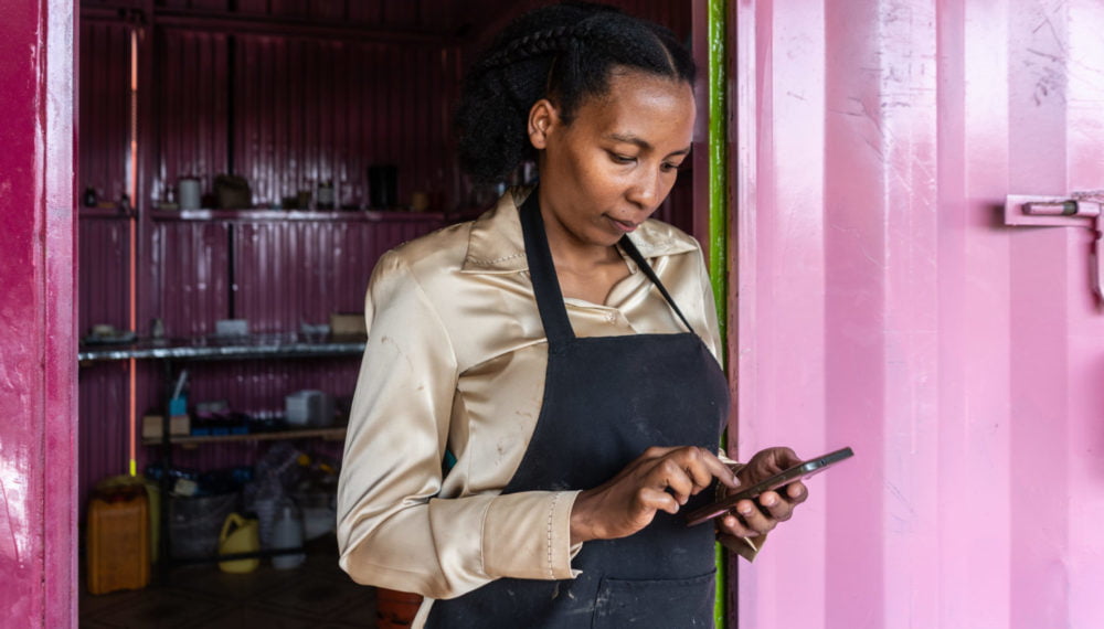 Wangari Mwaura is using the HeVenture app outside her workshop where she is producing organic soaps, in Kenol town, Kenya, on Wednesday, Sep. 30, 2020. Wangari Mwaura is using HerVenture, a busines skills training mobile app created by the Cherie Blair Foundation for Women. The app features seven learning ‘tracks’ on a range of needs, including launching a business, product innovation and expanding market access, and a new track focusing on e-commerce
