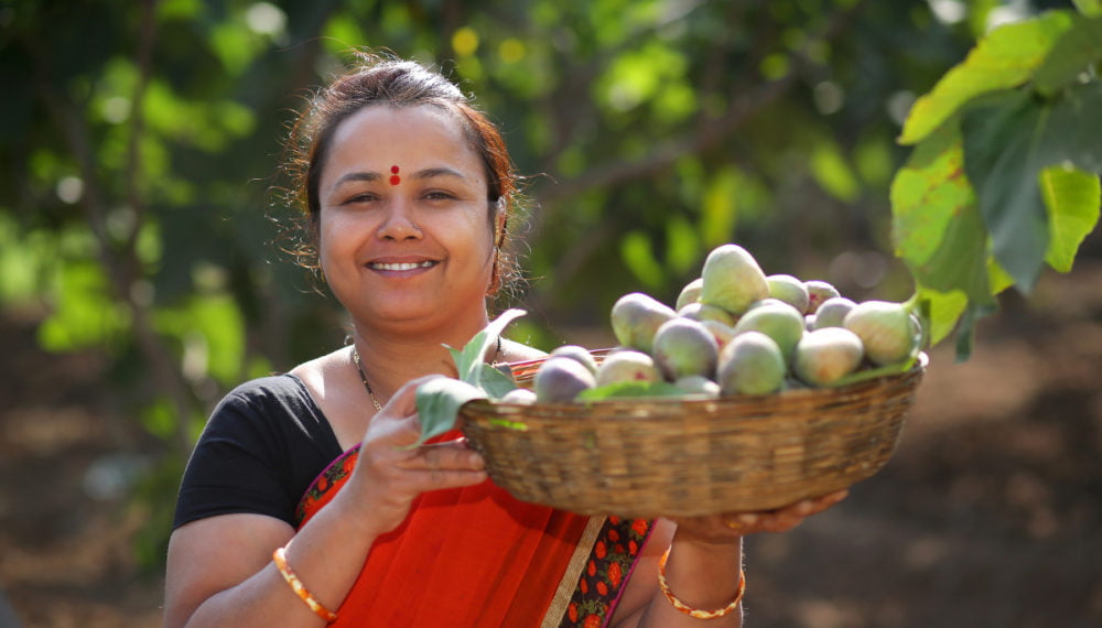 Neeta Mohan poses with fruit at her jam business.