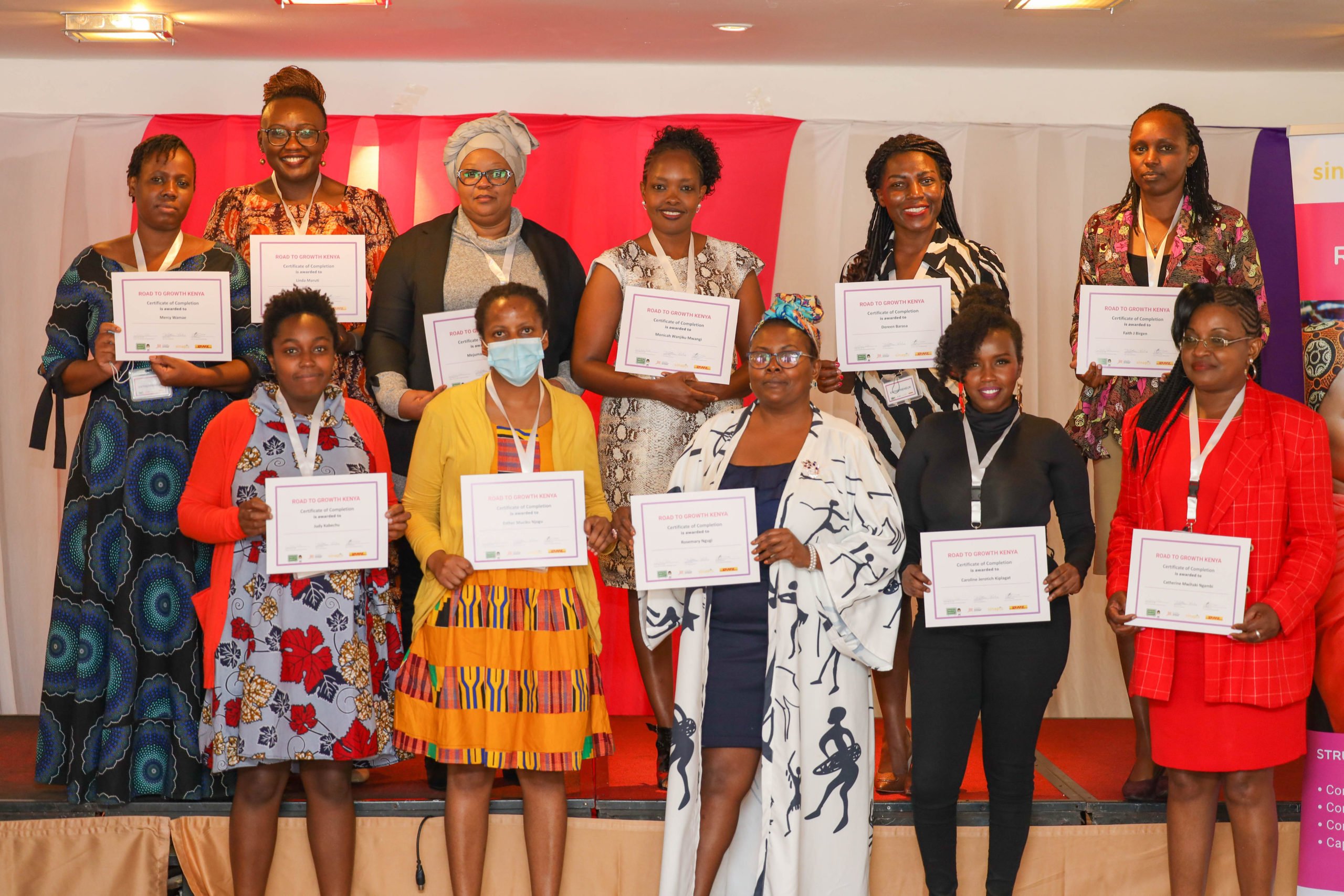 Road to growth graduates in Kenya pose with their certificates.