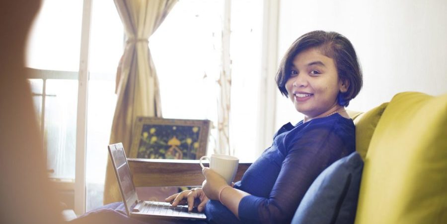 Mentoring Women in Business programme alumna works on her computer.