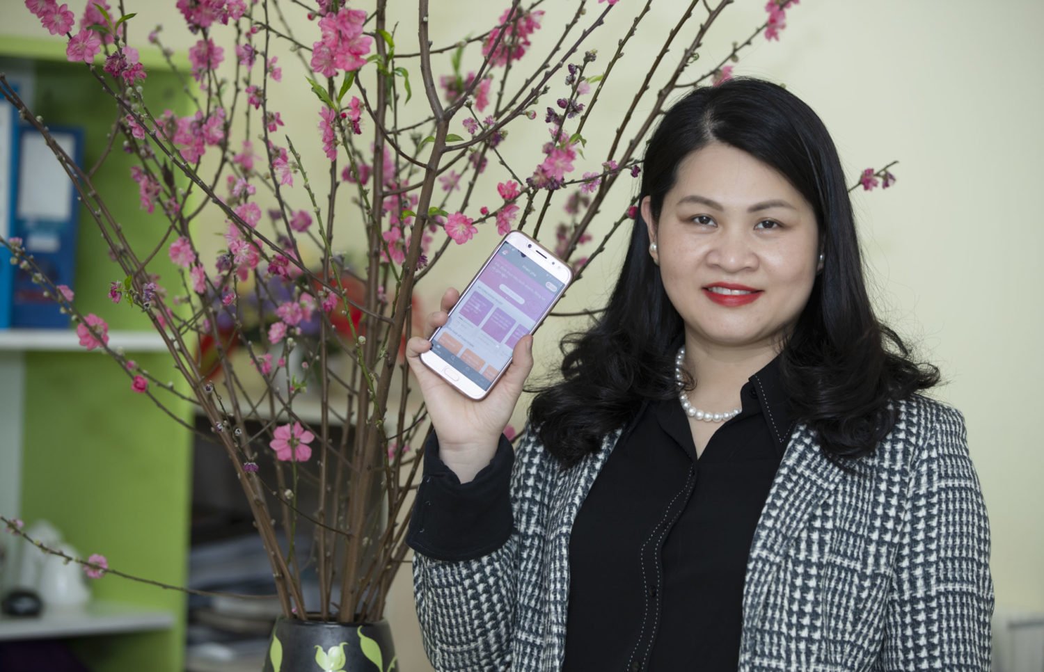 Yen Do, WEAVE participant in Vietnam, poses with the HerVenture app