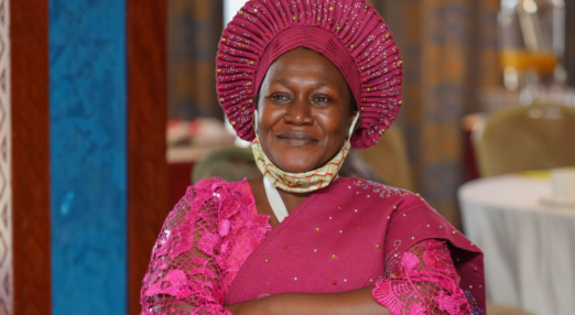 Woman entrepreneur smiles over her face mask
