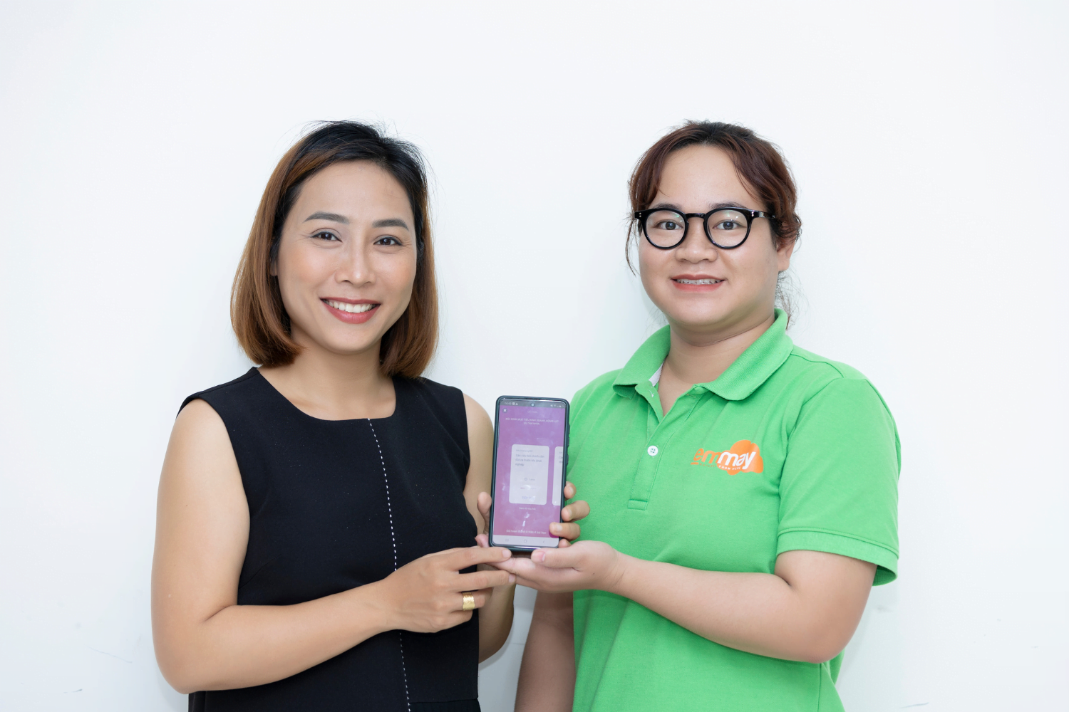 Van Pham and a staff member hold up the HerVenture app