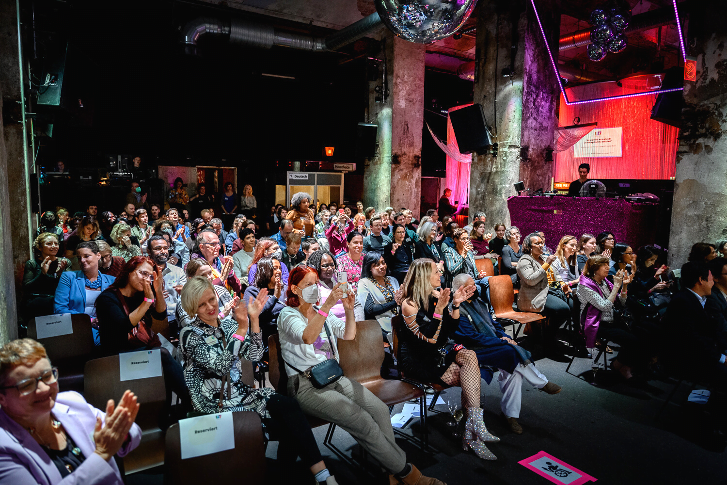 Audience claps at the W7 summit