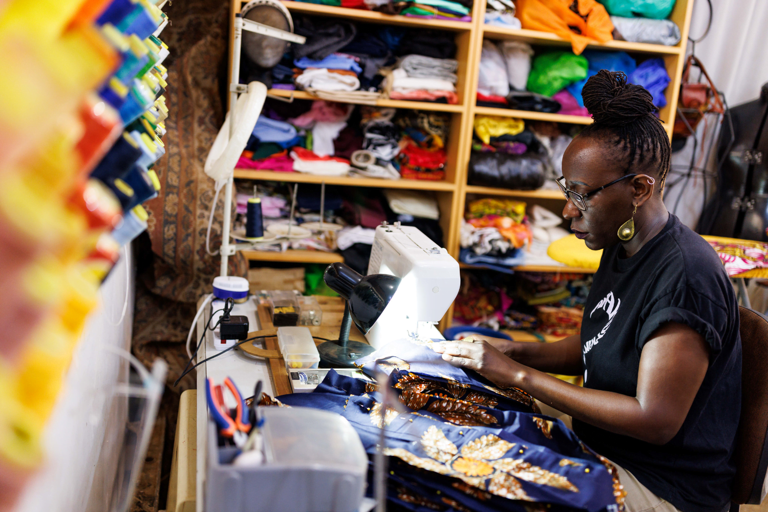 Suubi Njuki works on a sewing machine at her fashion business in Uganda.