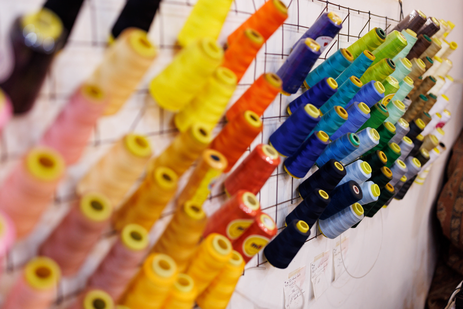 Colourful Spools of thread hang from the walls of Suubi Njuki's fashion business.