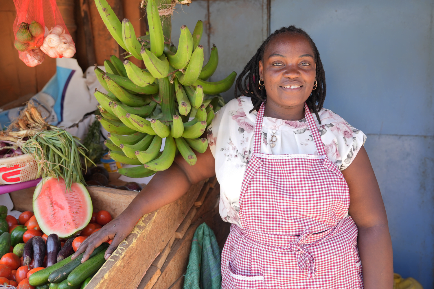 Jacqueline Muthoni Njogu, standing next to her produce business in Nairobi’s Giturai market.
