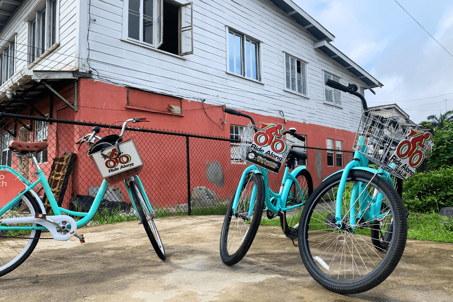 Three bicycles with baskets with the 'Ride Along' logo printed on them.