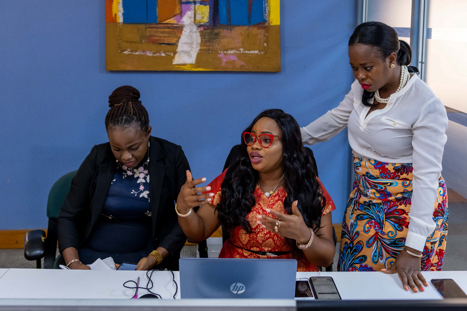 Sola Adesakin speaks with women at her business