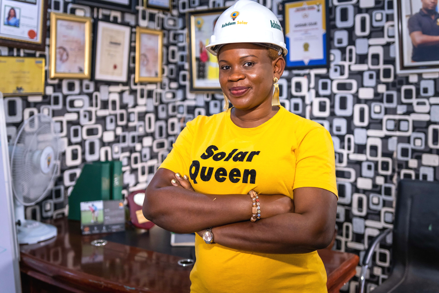 Damilola Asaleye, poses in a 'Solar Queen' shirt at the Ashdam Solar Company office