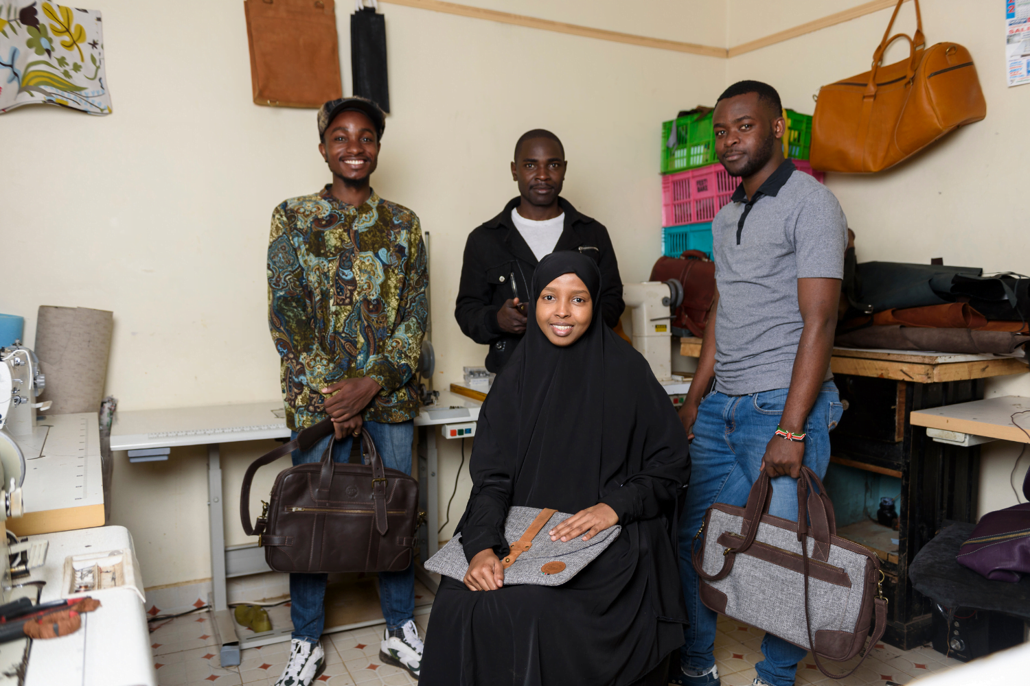 Muna Elmi and her staff smile with products