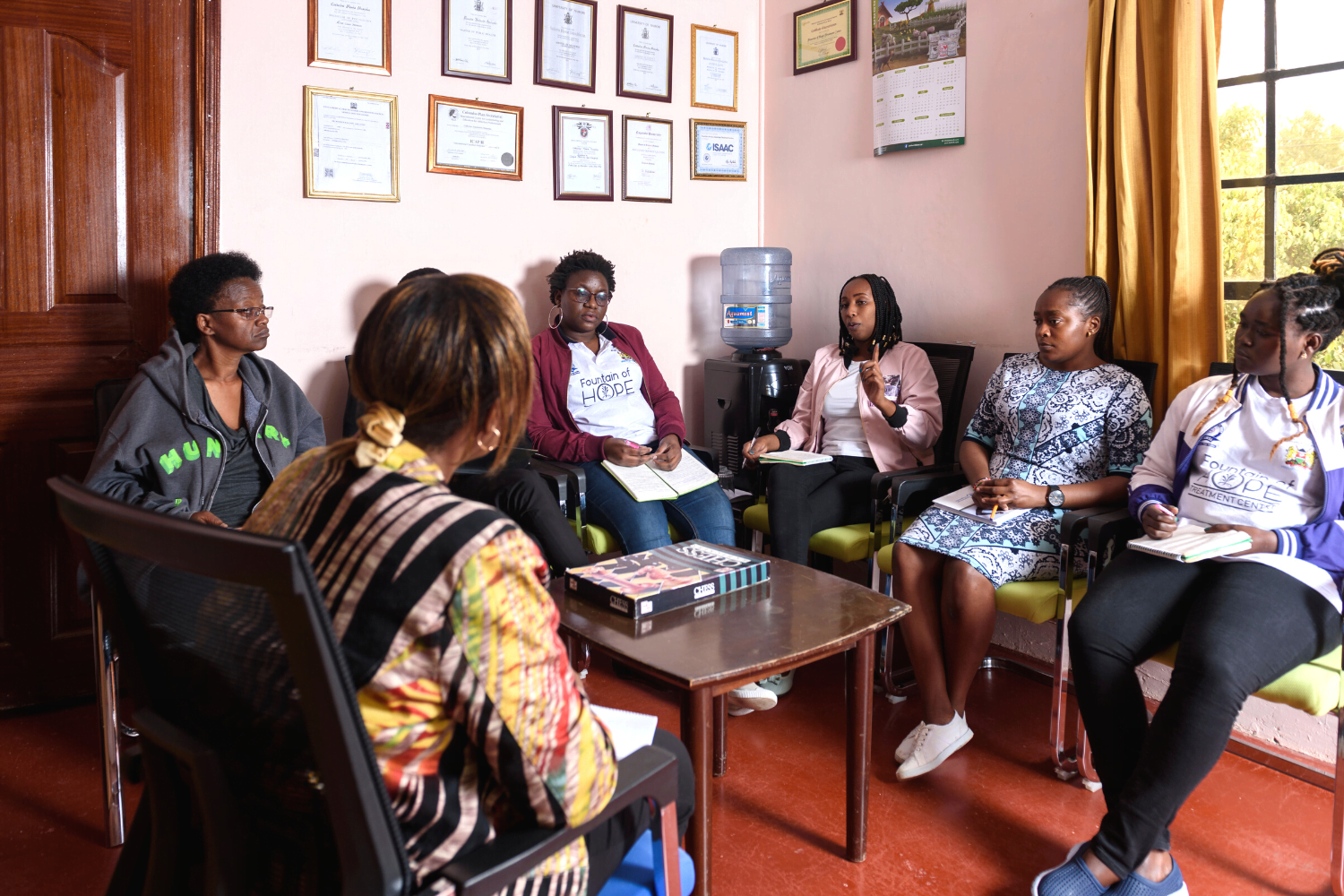 A group of people speak at Fountain of Hope mental health and addiction centre