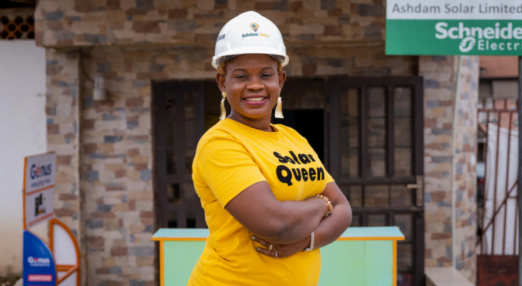 Damilola Asaleye poses in front of Ashdam Solar Company office