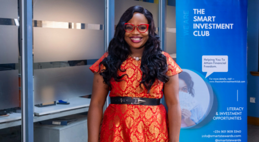 Sola Adesakin poses with The Smart Investment Club sign